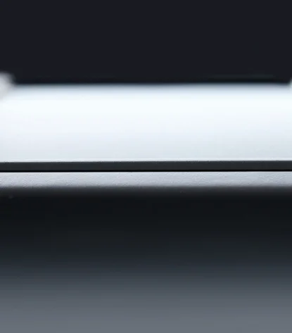 Close-up of a grey surface. On the left and right edges is grey leather that has been worked into the surface.