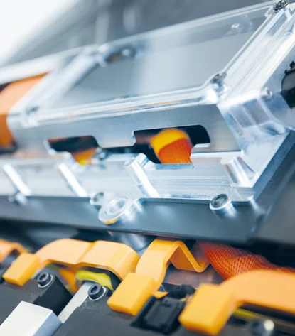 Close-up of a battery with orange components.