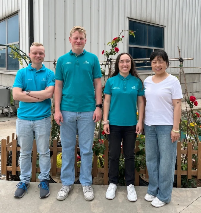 Group photo of the three trainees with a Chinese employee