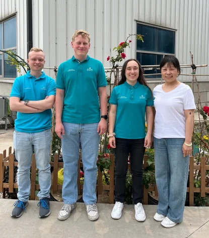 Gruppenfoto der drei Azubis mit einer chinesischen Mitarbeiterin