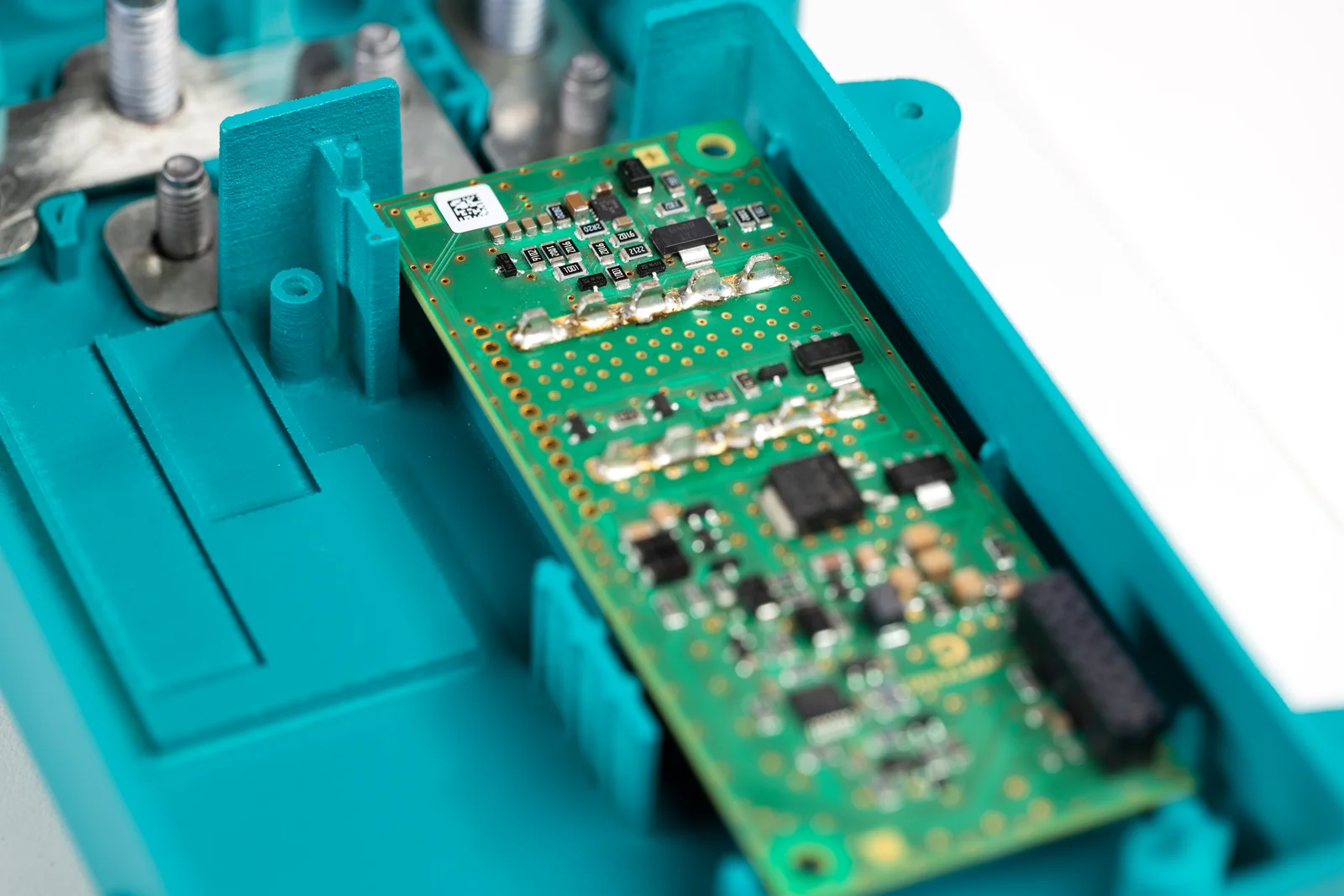 A rectangular dark green board lies on a turquoise surface.