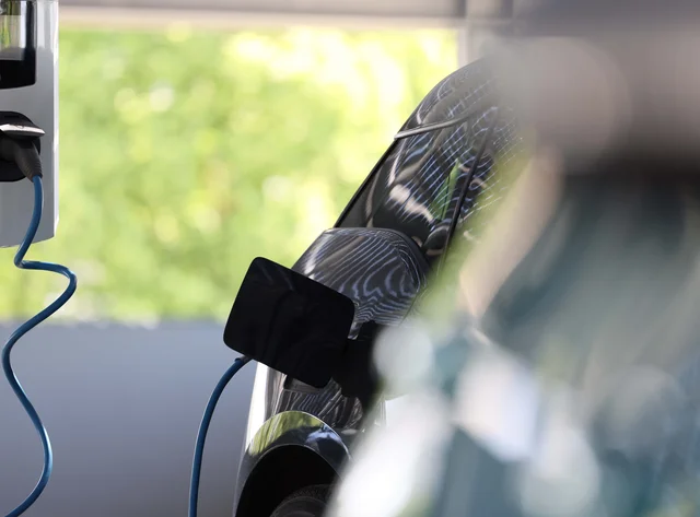 An e-vehicle is connected to an e-charging station. 