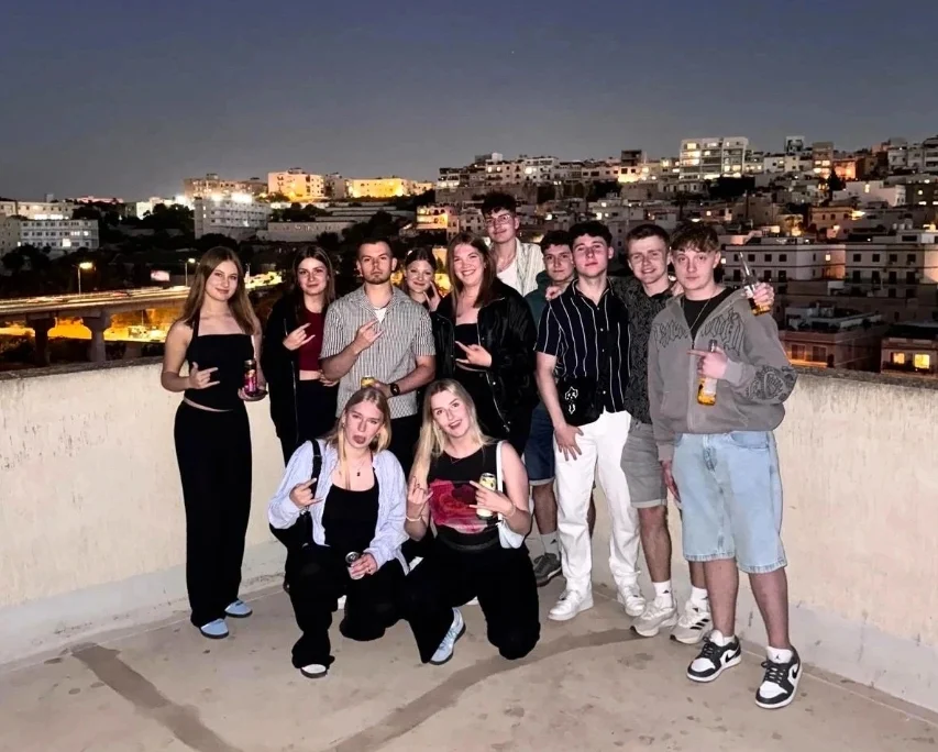 Group photo of the Malta travelers on an evening on the roof terrace
