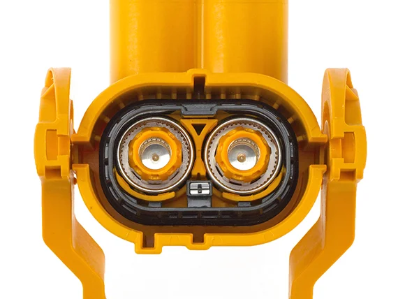 Two orange-coloured cables that end in a yellow, rectangular plug with two round connections.