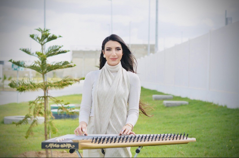 Fairouz is passionate about playing her Arabic harp.