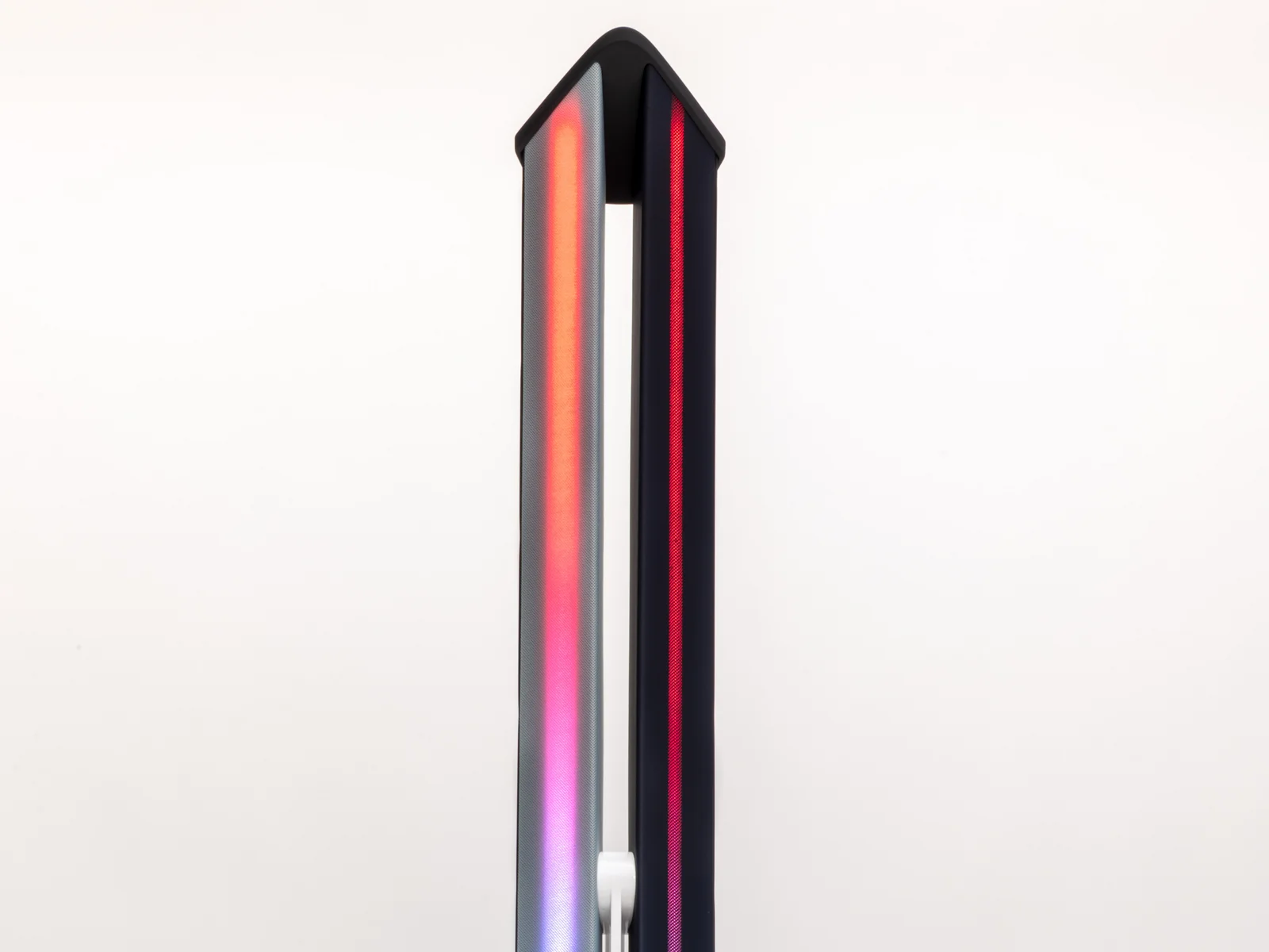 Vertical LED light strip with colour gradient from blue to white to red, mounted on a black base.