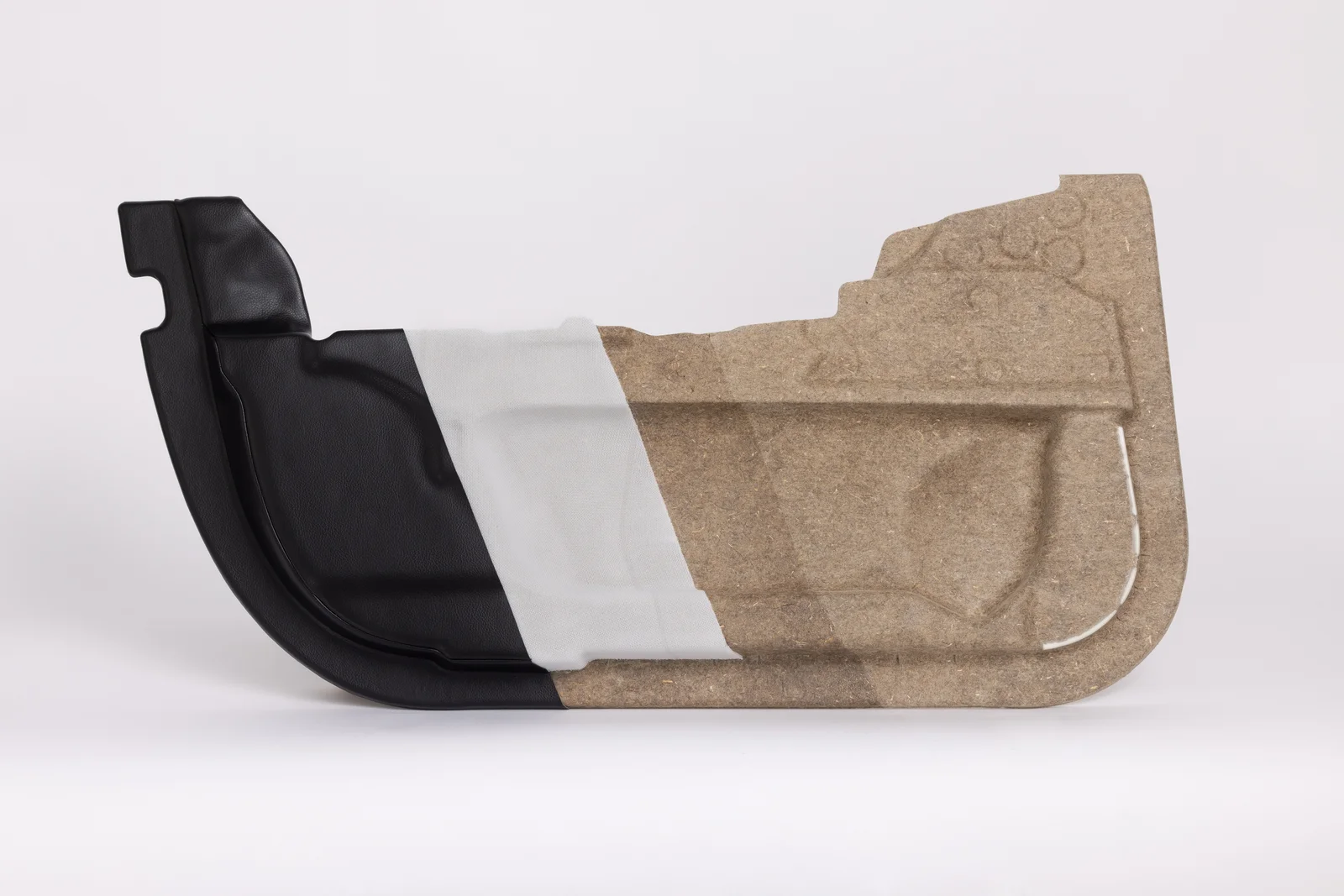 A car part with a combination of black, white and brown material.