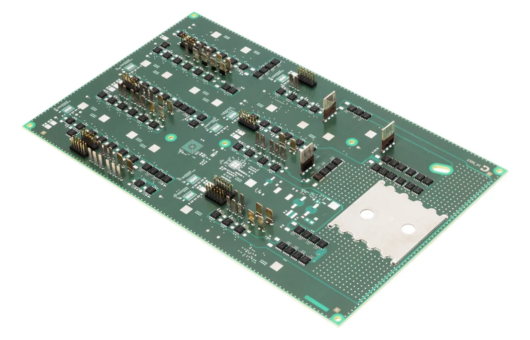 Green circuit board with several electronic components such as capacitors, resistors and connectors.